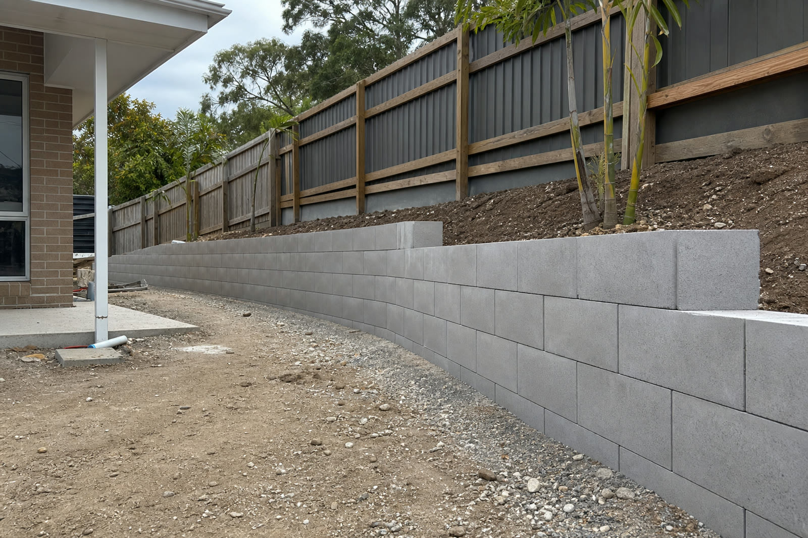 Block retaining wall installation for a sloped residential yard
