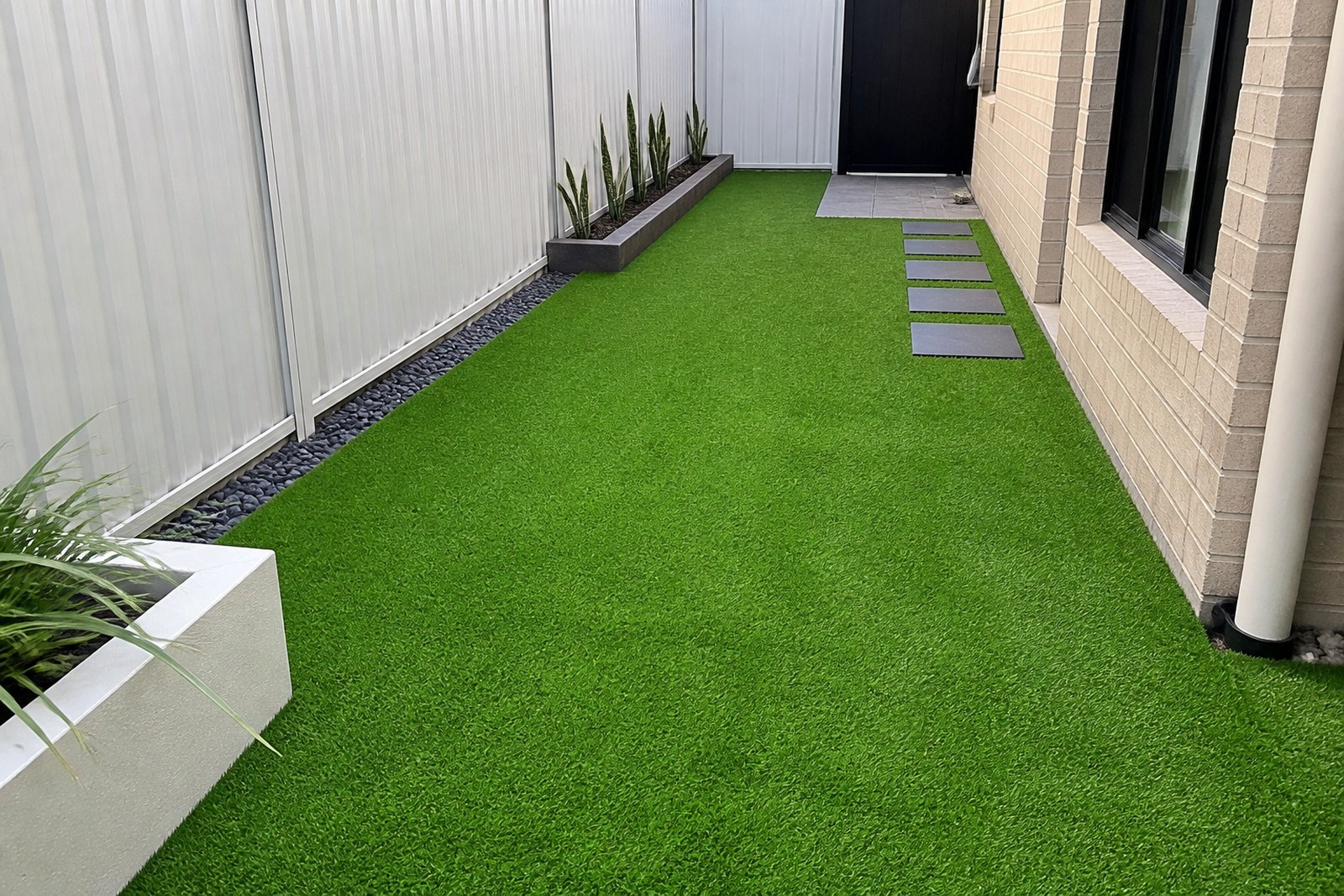 Synthetic turf installed in a narrow residential side yard